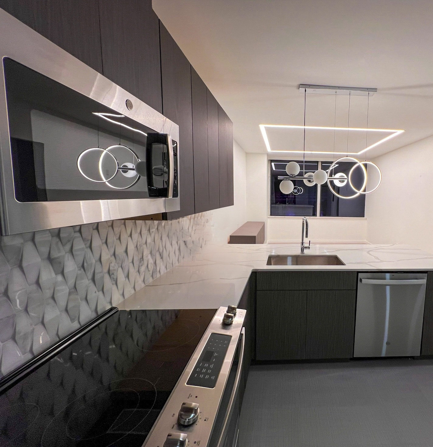 Dark cabinet kitchen with designer backsplash