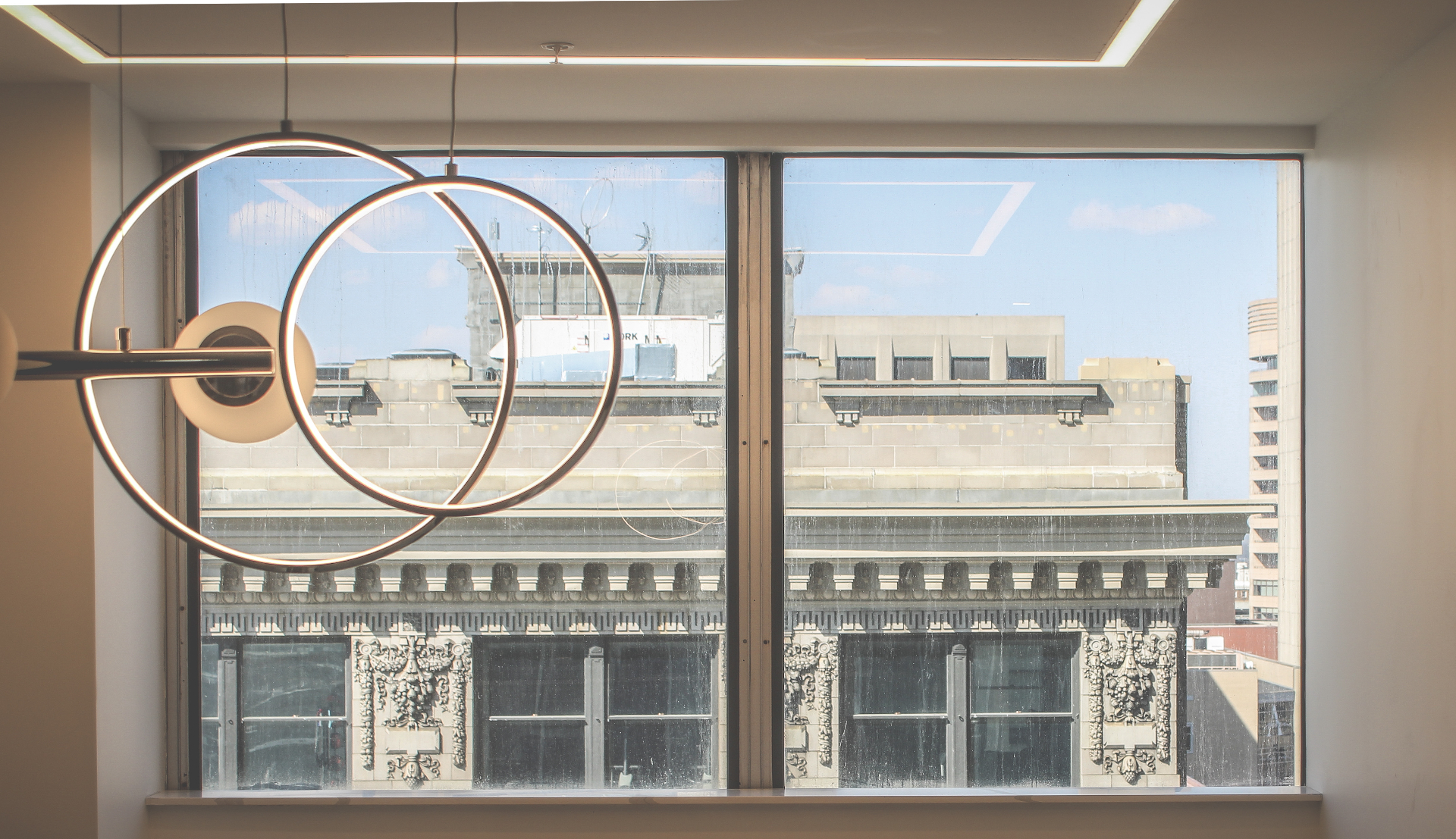 City view through window with modern light fixture