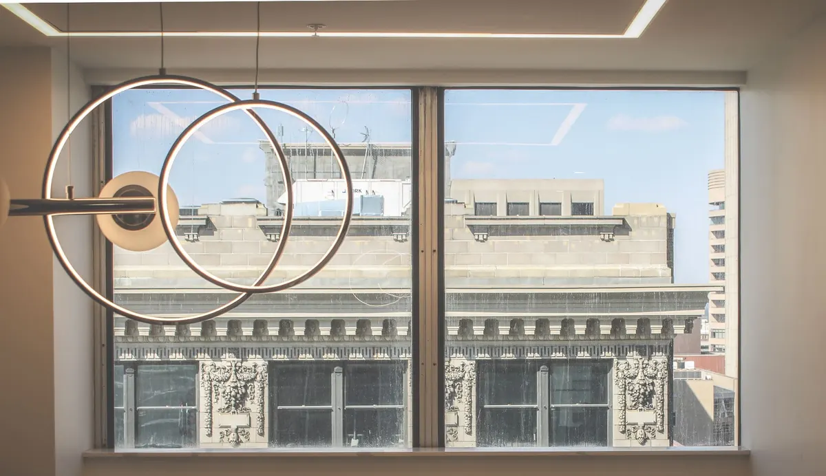 City view through window with modern light fixture